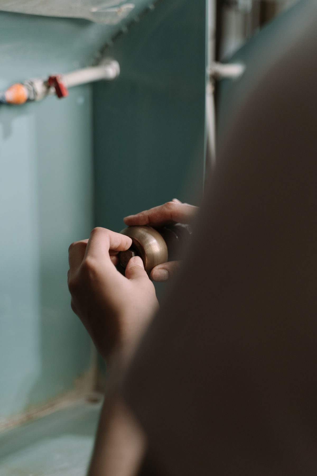 FlowRight plumber adjusting pipework beneath a kitchen sink