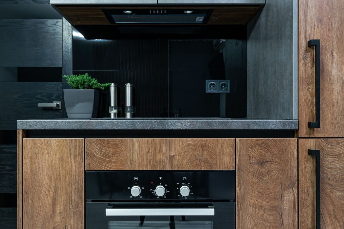 FlowRight technician repairing a kitchen oven and gas range