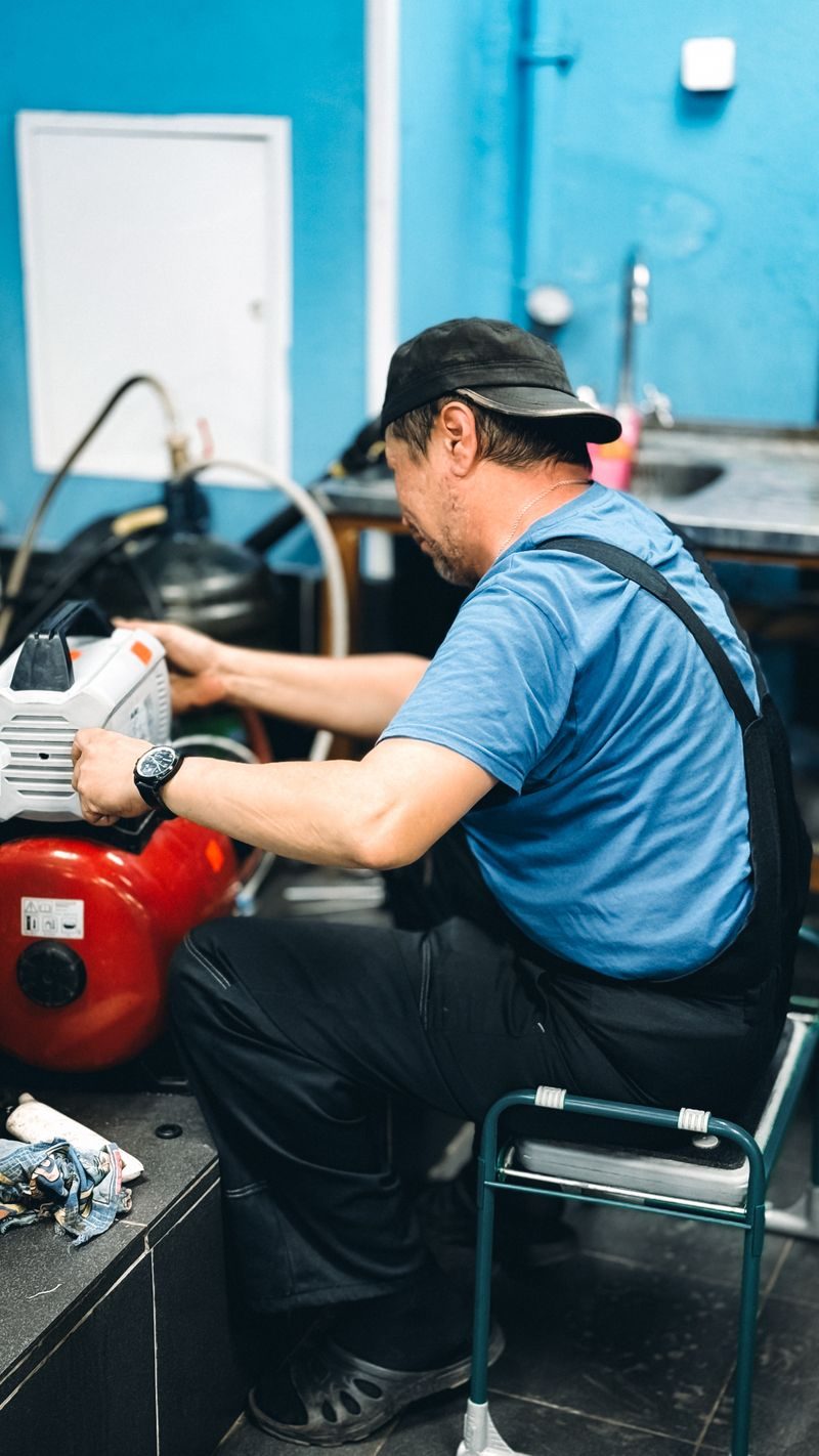FlowRight repairman servicing equipment in blue overalls